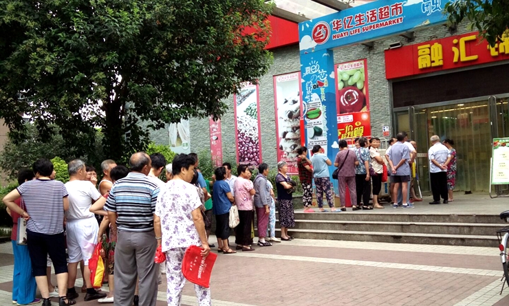 華億生活超市門前消費(fèi)者排隊(duì)進(jìn)入購物
